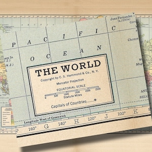 May include: A vintage world map with a blue background and black lines. The map is titled "The World" and includes a scale in statute miles. The map is copyright by C.S. Hammond & Co., N.Y. and features a Mercator Projection.