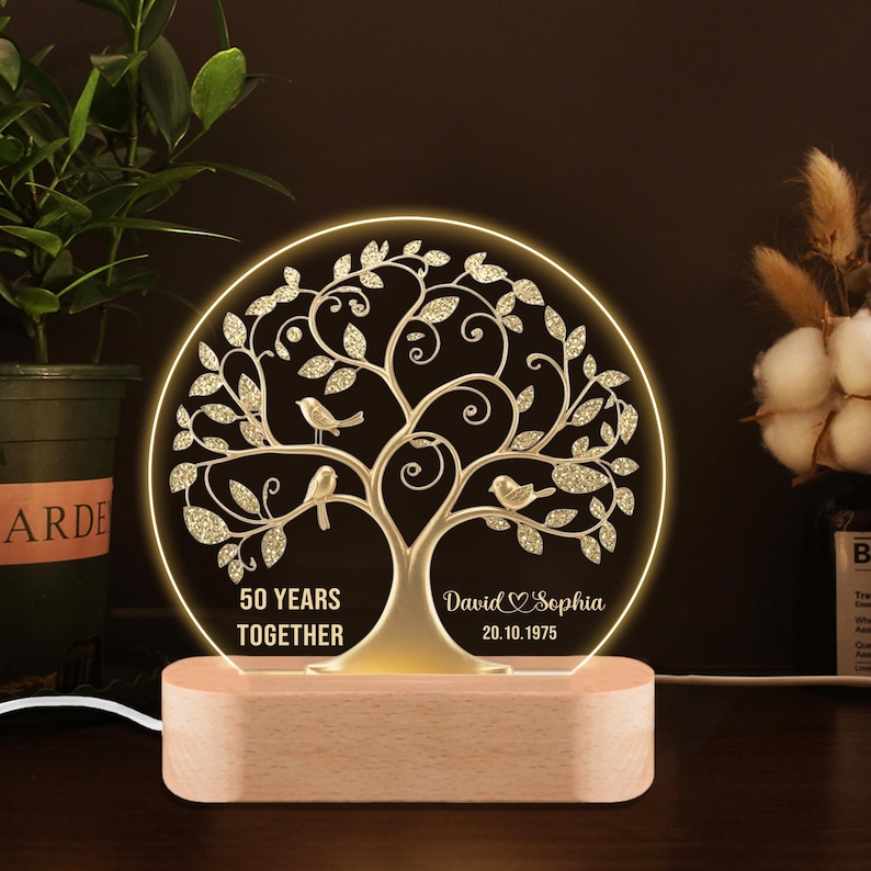 Personalized LED tree lamp for 50th anniversary, featuring couple’s names, wedding date, and glowing golden tree with love birds.