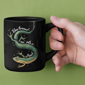 She Turned Me Into A Newt Black Mug, 11 Oz Black Ceramic Cup Mugs, Funny Witch Quote Kitchen Gift, Movie Quote Sarcastic Novelty Drinkware