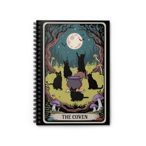 May include: Spiral-bound notebook featuring a whimsical illustration of black cats gathered around a cauldron under a full moon. The scene includes trees, mushrooms, and the text "THE COVEN" at the bottom, all in a colorful, cartoon style.