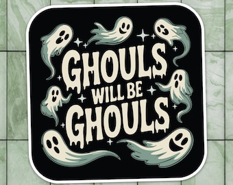 May include: A black sticker with the phrase "Ghouls Will Be Ghouls" in white, stylized lettering. The sticker features several cartoon ghosts in light blue, with smiling faces and star accents, perfect for Halloween.