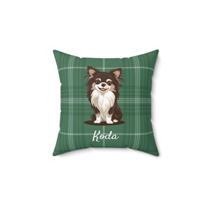 May include: Square throw pillow with a green plaid pattern. The pillow features a cartoon illustration of a brown and white Chihuahua dog with the name "Koda" in white script. The pillow is a decorative home accessory.