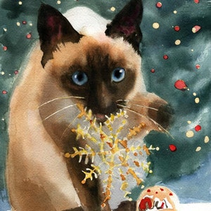 May include: Watercolor painting of a Siamese cat with blue eyes, holding a gold snowflake ornament in its mouth. The cat is set against a dark green background with red and yellow bokeh, and a small ornament on the ground.