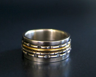 the fidget ring in oxidized sterling silver and 14k yellow gold