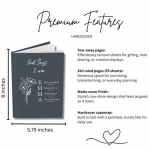May include: A dark gray hardcover journal measuring 8 inches by 5.75 inches. The cover features white text reading God Says I am, a floral illustration, and the name EMMA with the words Equipped, Merciful, Marked, and Accepted listed vertically.