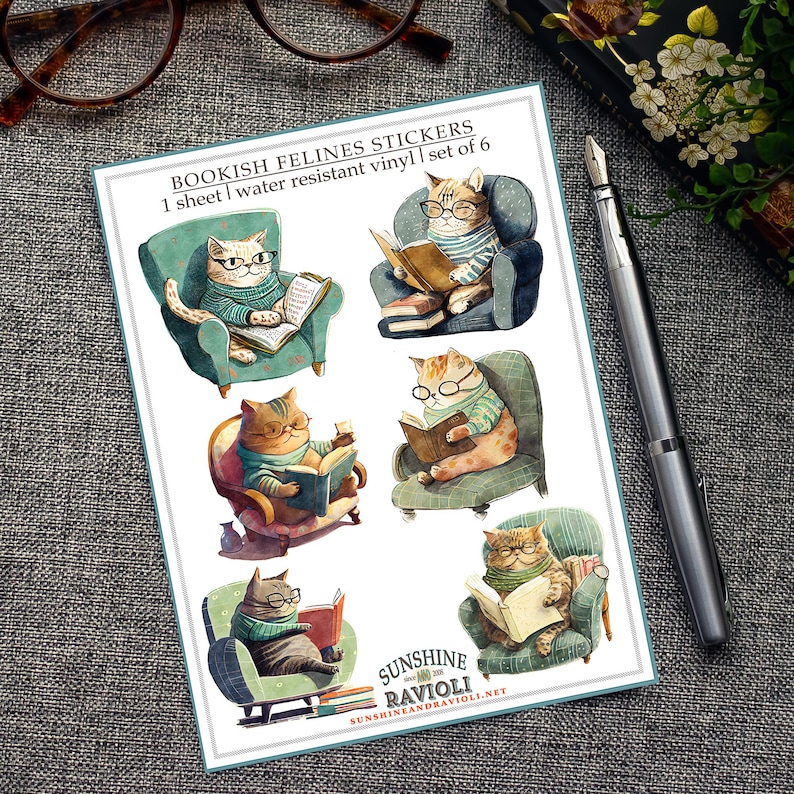 May include: A sheet of six water-resistant vinyl stickers featuring cats reading books in armchairs. The stickers are illustrated in a whimsical style with bright colors and detailed features. The text on the sheet reads "BOOKISH FELINES STICKERS 1 sheet | water resistant vinyl | set of 6 SUNSHINE RAVIOLI SUNSHINEANDRAVIOLI.NET".