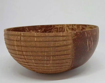 Handmade wooden bowl in the shape of a coconut shell for fruit food