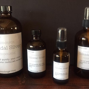 May include: Four amber glass bottles of colloidal silver, two with spray tops and two with screw tops. The bottles are labeled with the text "Colloidal Silver" and "senna+sage".