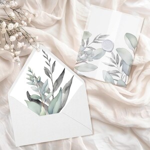 Könnte beinhalten: Ein weißer Umschlag mit einem Aquarell-Design aus grünen Blättern und Zweigen. Der Umschlag ist mit einem Wachssiegel versiegelt.