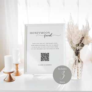 May include: White sign with black text that reads "Honeymoon Fund" with a QR code and the text "With love and joy, our hearts unite, your presence makes this day so bright. If you'd like to give a gift with cheer, it's not required, but we'd hold it dear. Claire & Andrew". The sign also includes a grey circle with the text "Includes 3 Sizes".