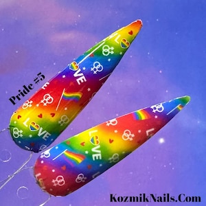 May include: Two rainbow-coloured nail wraps with a pride theme. The wraps feature a rainbow flag, hearts, stars, and the word "LOVE" repeated throughout. The text "Pride #5" is visible in the top left corner of the image.