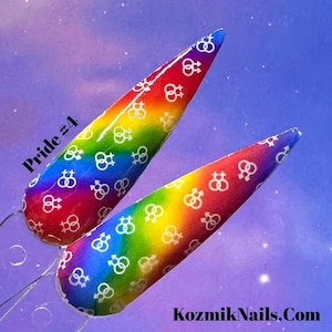 May include: Two rainbow-coloured nail tips with a white gender symbol pattern. The tips are arranged diagonally with the text "Pride #4" in the top left corner.