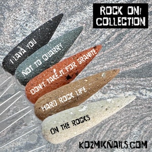 May include: Five nail polish bottles with a rock theme. The bottles are labeled "I Lava You", "Not To Quarry", "Don't Take It For Granite", "Hard Rock Life", and "On The Rocks".