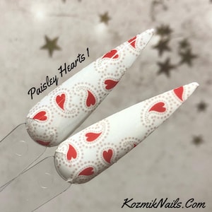 May include: Two nail art samples with a white base, featuring a paisley design with red heart shapes and small pink dots. The text "Paisley Hearts 1" is visible. The brand name "KozmikNails.com" is also displayed.