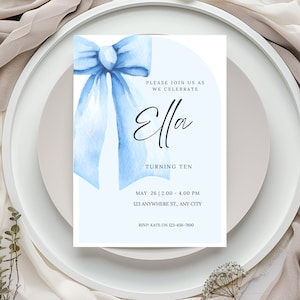 May include: A blue watercolor bow with a white background. The text "PLEASE JOIN US AS WE CELEBRATE Ella TURNING TEN MAY 26 12.00-4.00 PM 123 ANYWHERE ST., ANY CITY RSVP: KATE ON 123-456-7890" is printed on the invitation.