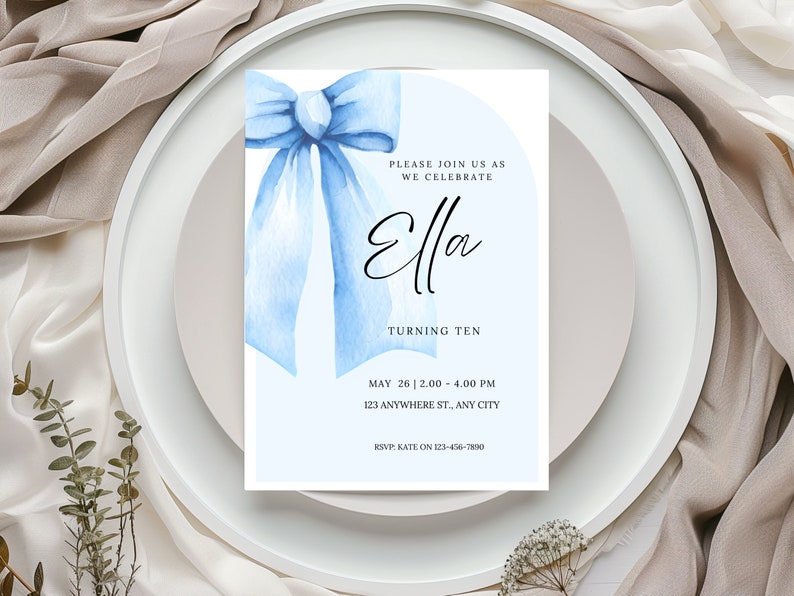 May include: A blue watercolor bow with a white background. The text "PLEASE JOIN US AS WE CELEBRATE Ella TURNING TEN MAY 26 12.00-4.00 PM 123 ANYWHERE ST., ANY CITY RSVP: KATE ON 123-456-7890" is printed on the invitation.