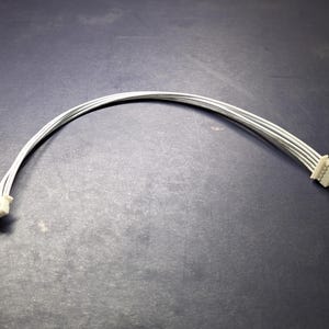 May include: A white six-wire cable with connectors on both ends.
