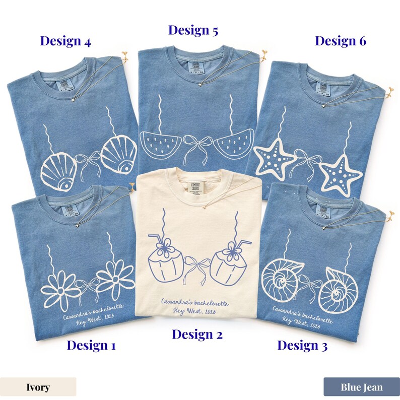 May include: A collection of blue jean and ivory t-shirts with various white graphic designs. Designs include seashells, bikini tops, starfish, flowers, and coconuts. Each shirt has a gold necklace and text that reads "Cassandra's bachelorette Key West, 2016."