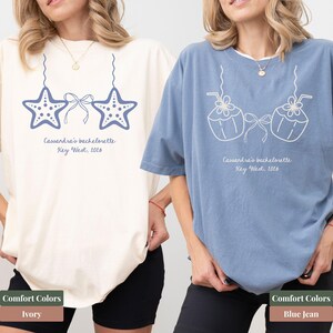 May include: Two t-shirts, one ivory and one blue, featuring a bachelorette party design. The ivory shirt has a starfish design, while the blue shirt has a coconut design. Both shirts include the text "Cassandra's bachelorette Key West, 2016".