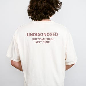 Undiagnosed But Something Ain’t Right Comfort Colors Shirt, Funny Sarcastic Tee, Mental Health Humor Graphic Shirt, Humor Gift Tee