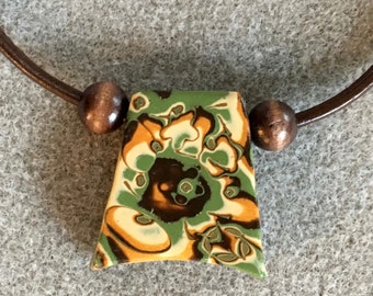 Dramatic polymer clay pendant necklace in an organic green, gold, brown, cream and copper design