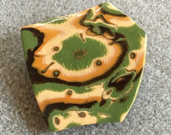 Dramatic polymer clay pin in an organic green, gold, brown, cream and copper design