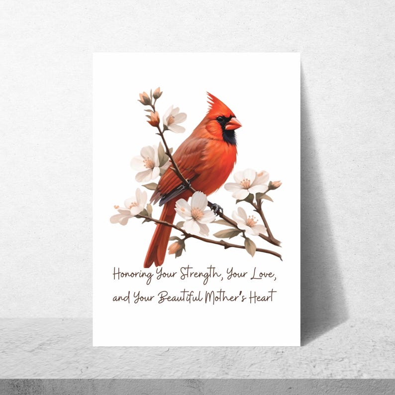 Puede incluir: Un p&aacute;jaro cardenal rojo posado en una rama con flores blancas. El texto "Honoring Your Strength, Your Love, and Your Beautiful Mother's Heart" est&aacute; debajo del p&aacute;jaro.