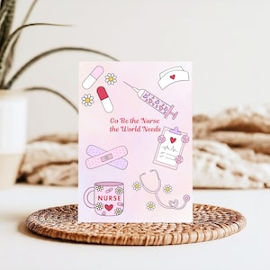 May include: A pink and white card with medical-themed illustrations, including a syringe, pills, bandages, a stethoscope, and a mug with the word "NURSE." The card also features the text "Go Be the Nurse the World Needs."