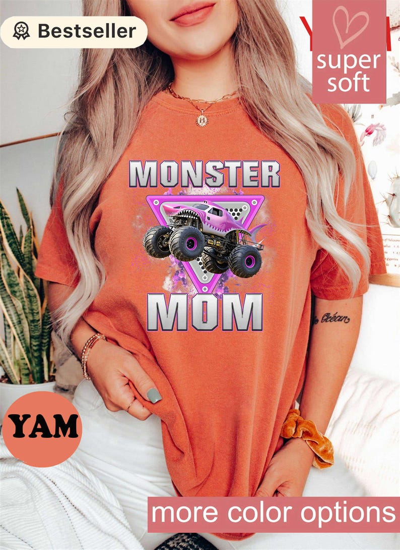 May include: Orange t-shirt with the text "MONSTER MOM" and a graphic of a purple monster truck. The shirt also has the text "super soft" and "more color options".