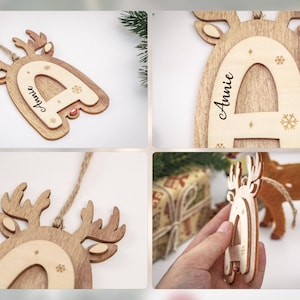 May include: A wooden reindeer-shaped Christmas ornament featuring a layered design with a light-colored letter A in the center. The ornament is engraved with the name Annie and small snowflake patterns, and it includes a jute twine loop for hanging.