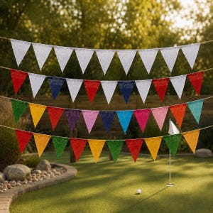 May include: Four horizontal strings of triangular pennant flags suspended in a row. The top string features white flags. The second string displays a repeating pattern of red, white, and blue flags. The third and fourth strings show multicoloured flags.