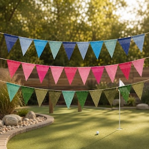 May include: Three horizontal strings of triangular pennant flags. The top row features shades of blue, the middle row displays various pink tones, and the bottom row consists of green flags. Each pennant has a textured appearance.