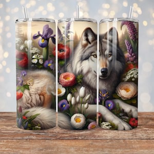 May include: A stainless steel tumbler with a wolf surrounded by flowers. The wolf is gray and white, and the flowers are pink, purple, and white.