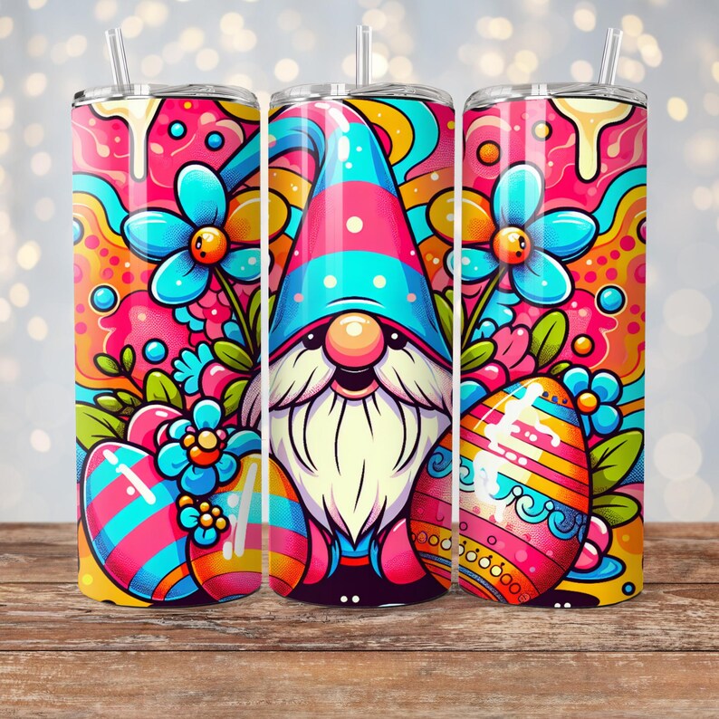 May include: A colorful Easter-themed tumbler with a gnome wearing a blue and pink hat, surrounded by flowers and Easter eggs. The tumbler has a straw and is perfect for spring.