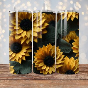 May include: Three stainless steel tumblers with a sunflower design. The tumblers are yellow and green with a black background.