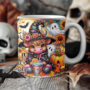 May include: A white ceramic mug with a colorful illustration of a cow wearing a witch hat and holding a pumpkin spice drink. The mug has the text "Treat a little spooky" on the side.
