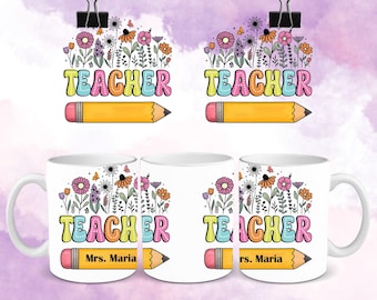 May include: White ceramic mug with a colorful floral design and the word "TEACHER" in a retro font. A yellow pencil graphic is below the word. The mug has a handle and the name "Mrs. Maria" is printed on the pencil.