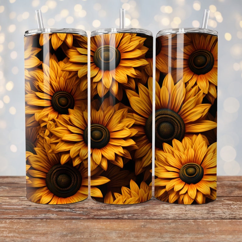 May include: Three stainless steel tumblers with a sunflower pattern. The tumblers are yellow and black and have a glossy finish.