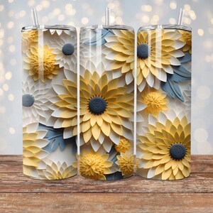 May include: Three stainless steel tumblers with a floral design. The tumblers feature a pattern of yellow, white, and blue paper flowers.
