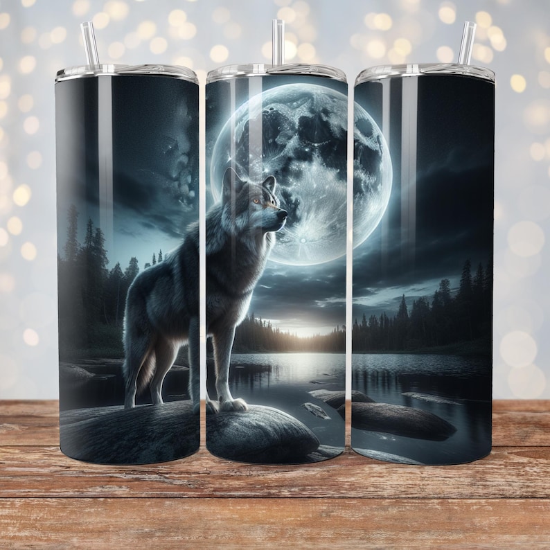 May include: Three stainless steel tumblers with a wolf silhouette standing in front of a full moon and a lake. The wolf is gray and white and the moon is a bright white.