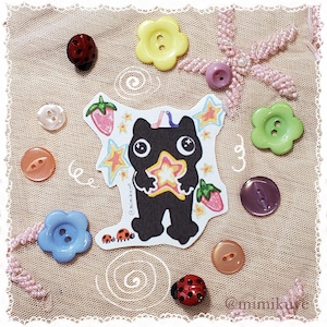 Sticker chat noir tenant une étoile