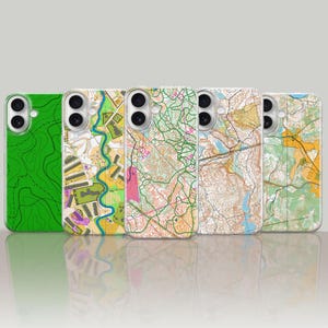 May include: Five phone cases with map designs. The cases feature a variety of colorful topographic maps in shades of green, yellow, brown, and white. The cases are displayed against a light background.