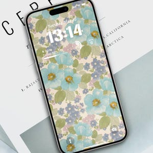 May include: A smartphone with a floral wallpaper featuring blue, purple, and pink flowers on a cream background. The time is displayed as 13:14 and the date is Tuesday, May 20. The weather forecast shows rain with 50% chance of precipitation.
