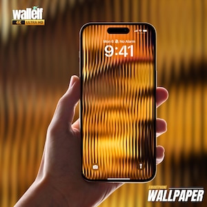 May include: A smartphone displaying a digital clock with the time 9:41 and the text "Mon 6 No Alarm". The background of the phone screen is a blurry image of a golden, textured surface.