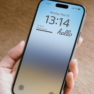 May include: A smartphone displaying a blue and yellow gradient background with the time 13:14 and the text "Monday, May 20" and "hello". The phone is 100% charged and the battery icon is visible. The phone is held in a hand.