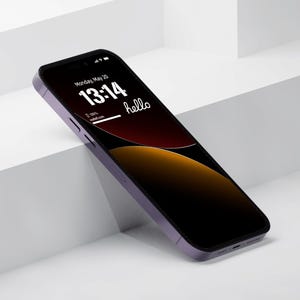 a cell phone sitting on top of a white surface