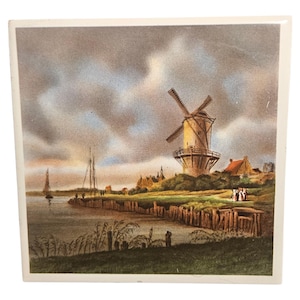 Può includere: Una stampa vintage raffigurante un paesaggio olandese con un mulino a vento, barche a vela e un cielo nuvoloso. L'opera presenta un mulino a vento su una collina erbosa, un corso d'acqua e un piccolo villaggio. La tavolozza dei colori include tonalità tenui di beige, marrone e blu.