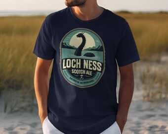 May include: A navy blue t-shirt with a vintage-style illustration of the Loch Ness Monster. The illustration is surrounded by a circle with the text "Loch Ness Scotch Ale" and "Brewed in the Highlands".