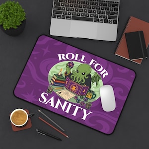 May include: A rectangular desk mat with a purple background featuring a green tentacled creature holding a twenty-sided die. The text reads ROLL FOR SANITY. The illustration includes books, a candle, a dungeon master screen, dice, and a mug.