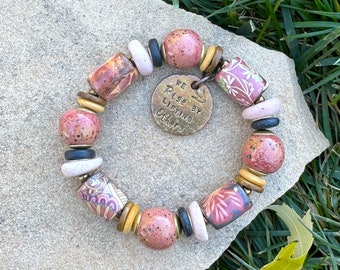 Handmade Artisan Ceramic Beads with Coconut and Wood Spacers with Brass and Charm 'We Rise By Lifting Others' Pink Red Cream